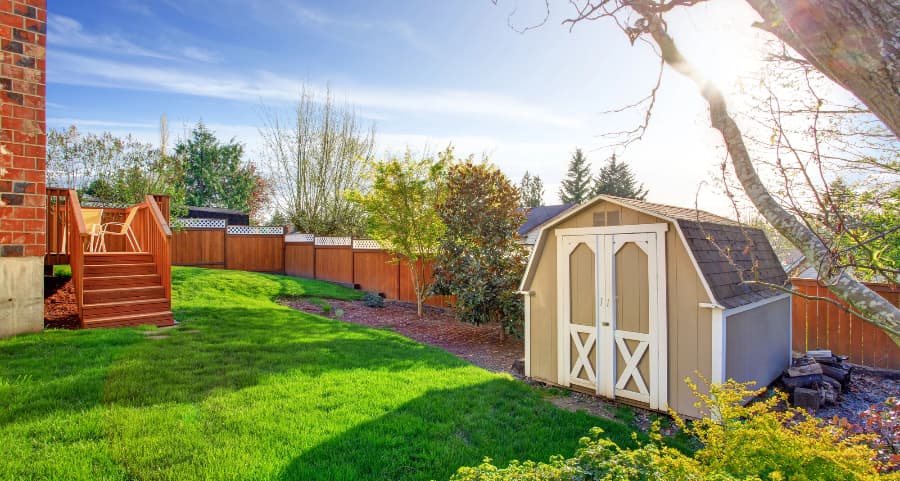 Fenced backyard with storage shed in Rockford